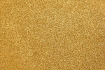 Gold background glitter. Gold sparkling. Glitter particles. Golden color. Noble paper. Gold Coated Paper. Rough surface. Valuable, expensive. Background for designs. Gold paper texture. Gold foil. - obrazy, fototapety, plakaty