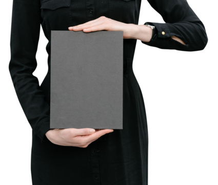 Black book cover in woman's hands. Book cover