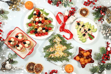 Christmas New Year dishes 2024, traditional holiday salads in the form of fir trees and fetax with tomatoes, olives and cheese, decorated with fir branches, cones and decorations, dish design idea,