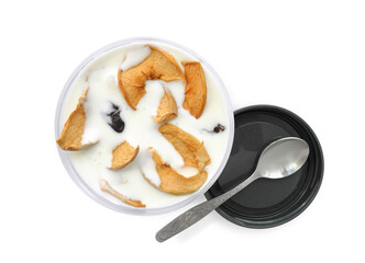Yogurt or kefir with dried fruits in plastic container with lid and spoon isolated on white background top view. Natural healthy snack.              