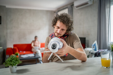 one man install setup home security surveillance camera on smartphone