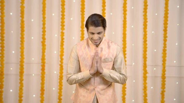 Indian man welcoming guests on Diwali
