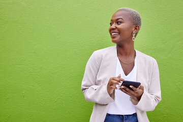 Woman, thinking and phone for communication by a wall or green background with internet. Happy African female person outdoor with a smartphone for social media, networking app and chat mockup space