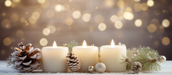 Christmas and winter decorations including white candles fir branches cones and wreaths Symbolizes New Year and holiday season