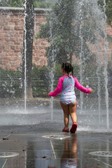 A Girl Playing in a Water Fountain
