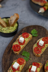 Salty snacks served on a wooden board.