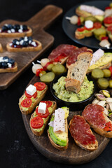 Sweet and savory snacks on a black background.