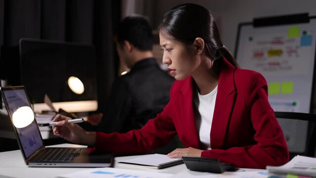 Serious businesswoman working overtime in the office are having stress from overworking and missing deadlines.