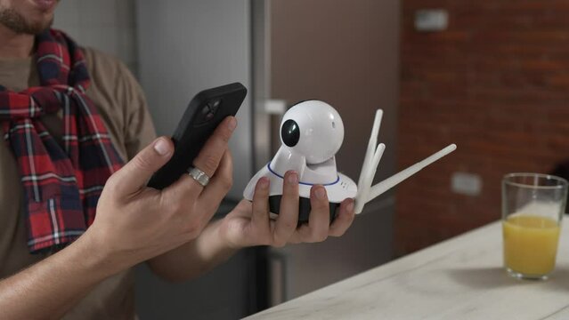 one man install setup home security surveillance camera on smartphone