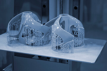 Printed models on 3D printer close-up. Objects printed on photopolymer sla 3D printer from liquid...