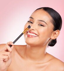 Beauty, portrait and happy woman with makeup brush in studio for cosmetic wellness on pink background. Smile, face and female model with tool for powder, contour and foundation, glamour or routine