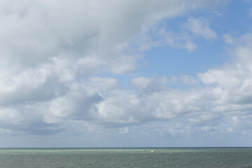 Beach cabins and seashore in Gouville sur Mer, Manche, Normandy, France in various lights