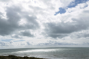 Beach cabins and seashore in Gouville sur Mer, Manche, Normandy, France in various lights