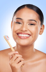 Happy woman, portrait and toothbrush in studio for dental cleaning, gingivitis or gums on blue...