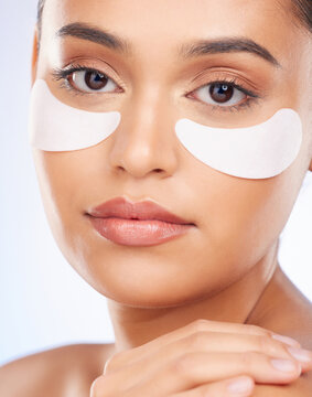 Skincare, beauty and portrait of woman with collagen eye patch for anti aging or skin pad on white background. Cosmetics, facial detox and model with luxury mask or product for dermatology in studio.