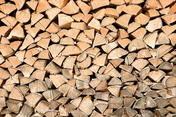 firewood wooden row as background or pattern. Background of stacked chopped wood logs. Pile of wood...