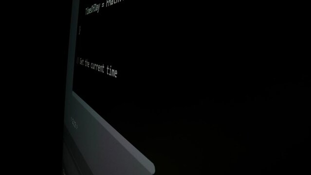 Closeup macro shot movement of coding script moving across LED screen with real-time AI-generated typing, showcasing advanced AI learning in optimization, debug and coding for software development.