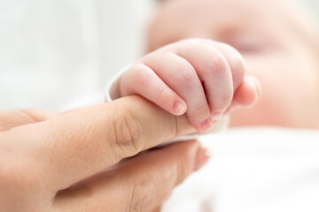 Gentle touch speaks a thousand words. Concept of the silent dialogue between mother and newborn
