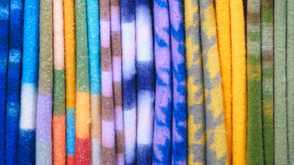 multi-colored wool bedspreads blankets scarves plaids in the market