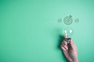 Hand with light bulb and target icon, Business strategy planning management, Progress of business...