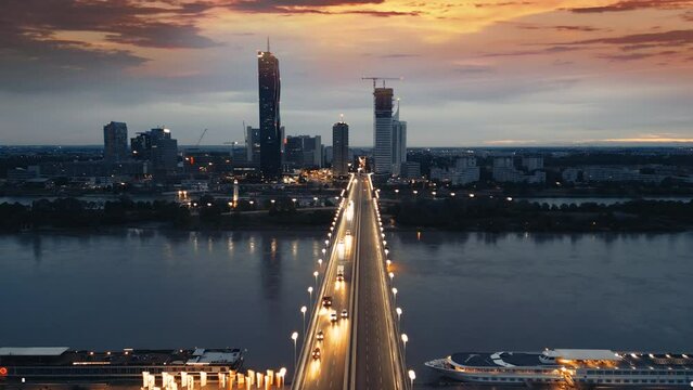 Vienna night aerial skyline view, drone footage of viena city skyline fly over bridge at night, vienna skyscrapers austria from above top view.