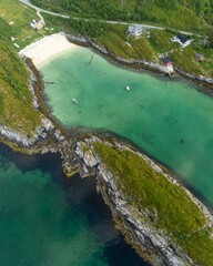 Obraz premium Aerial drone view of crystal water and Laukvika beach on senja island in norway
