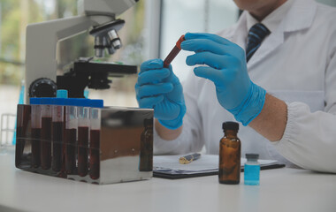 Scientist or medical in lab coat working in biotechnological laboratory, Microscope equipment for...