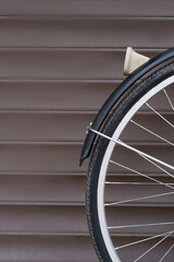 bicycle wheel on brown gate background