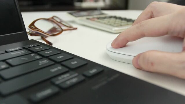 Businesswoman hand using and clicking on mouse for wireless working, online study, playing game on laptop, Business concept.