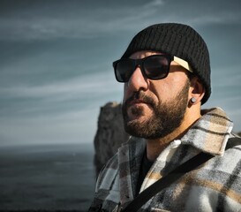 man with glasses and wool hat at a gazebo