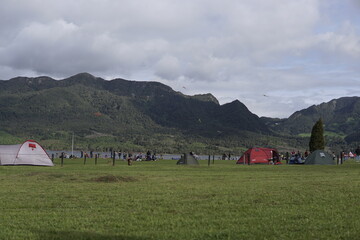 Neusa, Colombia; august 19, 2023: People enjoy with their families and pets in the dam of Neusa, flying kites