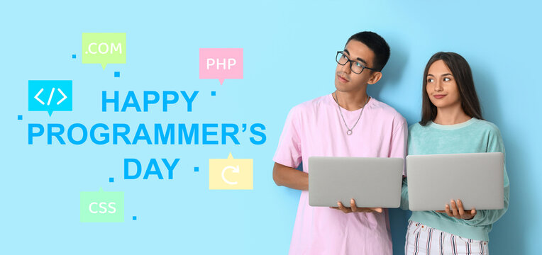 Young couple with laptops on blue background