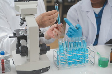 Scientist or medical in lab coat working in biotechnological laboratory, Microscope equipment for...