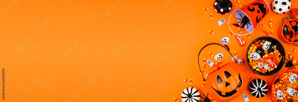 Poster halloween trick or treat side border with jack o lantern pails and mixed candy. above view on an ora