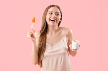 Pretty young woman with sugaring paste on pink background