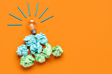 Light bulb with crumpled paper on color background. Logic concept