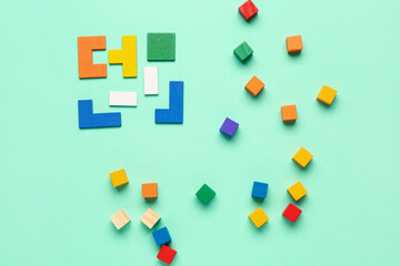 Colorful blocks with cubes on green background. Logic concept