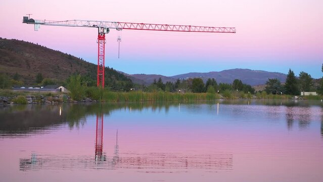 Nottingham lake park in Avon, Colorado in sunrise morning with construction crane in small mountain village town city in fall autumn