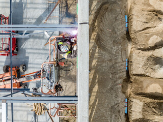 construction workers on a construction site welding the roof structure
