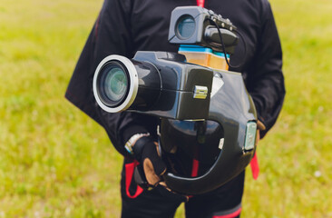Parachute helmet with an installed DSLR camera in the hands of a skydiver, cameraman and air...