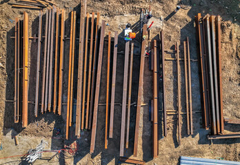 steel beams lying on the ground in an artistic pattern