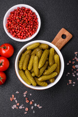 Delicious small pickled cucumbers gherkins with onions, mustard, salt and spices