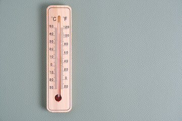 Wooden outdoor thermometer green background.
