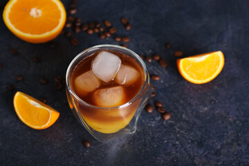 Glass of cold orange espresso on dark blue background