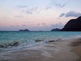 Serene Dusk at Waimanalo Beach with Lapping Waves and Rabbit Island in the Distance