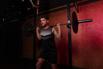 Man performing barbell squats