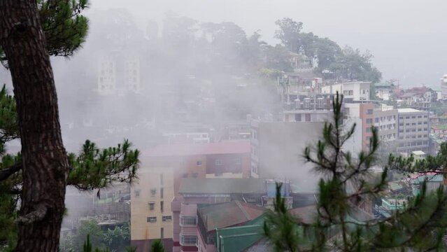 Buildings Enveloped By Drifting Fog