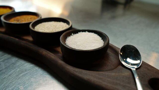 close-up of oriental spices standing on a metal counter in a professional kitchen in an Asian restaurant
