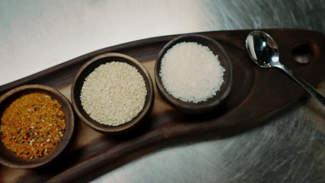 close-up of oriental spices standing on a metal counter in a professional kitchen in an Asian restaurant top view