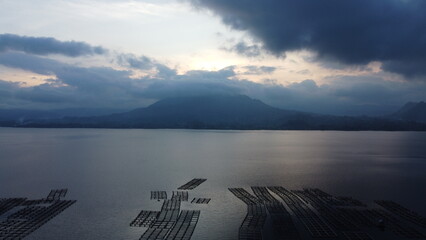 Drone view of Indonesian volcano Batur in the tropical island Bali. Danau Batur, Indonesia. Lake in sunset, touristic hiking place